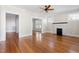 Spacious living room with gleaming hardwood floors, neutral paint, and a decorative fireplace at 409 N Hyde Park Ave, Durham, NC 27703