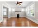 Inviting living room with hardwood floors, fireplace, neutral paint, and abundant natural light at 409 N Hyde Park Ave, Durham, NC 27703