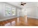 Sun-filled living room with hardwood floors, neutral paint, and direct access to other rooms at 409 N Hyde Park Ave, Durham, NC 27703