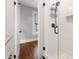 Tiled shower with glass door, upgraded fixtures, and integrated storage niche at 409 N Hyde Park Ave, Durham, NC 27703
