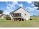 Backyard of the home featuring an elevated screened porch and a spacious lawn at 41 Tan Oak Dr, Selma, NC 27576