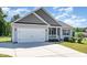 Single-Gathering home with a two-car garage, landscaped lawn, and covered front porch at 41 Tan Oak Dr, Selma, NC 27576