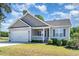 Single-Gathering home with a two-car garage, landscaped lawn, and covered front porch at 41 Tan Oak Dr, Selma, NC 27576