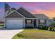 Charming single-Gathering home with a two-car garage, landscaped lawn, and covered front porch at 41 Tan Oak Dr, Selma, NC 27576