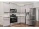 Bright kitchen featuring stainless steel appliances and plenty of cabinet space at 41 Tan Oak Dr, Selma, NC 27576