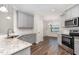 Updated kitchen featuring granite countertops, stainless steel appliances, and wood floors at 41 Tan Oak Dr, Selma, NC 27576
