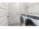 Well-equipped laundry room with modern washer and dryer units, and ample storage space at 41 Tan Oak Dr, Selma, NC 27576