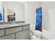 Bathroom with gray vanity, granite countertop, and fun blue shower curtain at 421 Gilpin Way, Cary, NC 27519