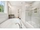 This bathroom features a soaking tub, walk-in shower, vanity, and large window at 421 Gilpin Way, Cary, NC 27519