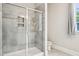 Bathroom with a glass-enclosed shower featuring tiled walls and built-in shelving at 421 Gilpin Way, Cary, NC 27519