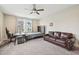 This is a bedroom with a ceiling fan, bed, sofa, desk, and two windows at 421 Gilpin Way, Cary, NC 27519