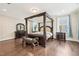 This bedroom has a four-post bed, wood floors, bench, dresser, and two nightstands at 421 Gilpin Way, Cary, NC 27519