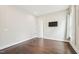 Bedroom with hardwood floors, neutral paint and a wall-mounted television at 421 Gilpin Way, Cary, NC 27519