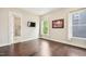 Bedroom boasts hardwood floors, natural light, and a mounted flatscreen TV at 421 Gilpin Way, Cary, NC 27519