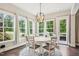 Bright dining area featuring a round table, wood floors, and large windows overlooking the outdoor scenery at 421 Gilpin Way, Cary, NC 27519