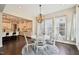 Well-lit dining area boasts wood floors, stylish light fixture, and seamlessly connects to the gourmet kitchen at 421 Gilpin Way, Cary, NC 27519