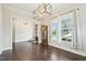 Well-lit dining room showcasing hardwood floors, natural light, a modern chandelier, and elegant trim work at 421 Gilpin Way, Cary, NC 27519