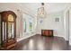 Elegant dining room featuring hardwood floors, natural light, a stylish chandelier, and elegant furnishings at 421 Gilpin Way, Cary, NC 27519