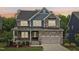 Beautiful two-story home with a stone and siding facade, well-maintained lawn, and inviting front porch at 421 Gilpin Way, Cary, NC 27519