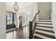 Spacious foyer featuring hardwood floors, an elegant staircase, and views into the dining and living areas at 421 Gilpin Way, Cary, NC 27519
