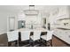 Spacious kitchen with island seating, stainless steel appliances, white cabinetry, and modern lighting fixtures at 421 Gilpin Way, Cary, NC 27519