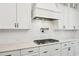 Modern kitchen featuring white cabinets, granite countertops, stainless appliances, and a tile backsplash for a clean aesthetic at 421 Gilpin Way, Cary, NC 27519