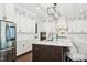 Modern kitchen featuring white cabinets, stainless appliances, large island, and sleek hardware for a modern look at 421 Gilpin Way, Cary, NC 27519