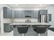 Kitchen featuring grey cabinetry, stainless steel appliances, and granite countertops at 421 Gilpin Way, Cary, NC 27519
