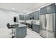 Kitchen featuring grey cabinetry, stainless steel appliances, and granite countertops at 421 Gilpin Way, Cary, NC 27519