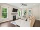 Cozy living room featuring a stone fireplace, hardwood floors, natural light, and a comfortable sofa at 421 Gilpin Way, Cary, NC 27519