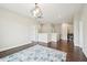 Upstairs loft area with hardwood floors, modern light fixture, and laundry room access at 421 Gilpin Way, Cary, NC 27519