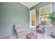 Inviting covered patio with comfortable seating area, a view inside the home, and serene outdoor ambiance at 421 Gilpin Way, Cary, NC 27519