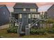 Beautiful rear exterior of a two-story home, featuring decks and a well-maintained yard at dusk at 421 Gilpin Way, Cary, NC 27519