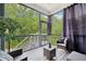 Relaxing screened porch featuring wooded views and comfortable seating for enjoying the outdoors at 421 Gilpin Way, Cary, NC 27519