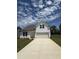 Charming two-story home with a well-manicured lawn and a long concrete driveway leading to the attached garage at 468 Winding Creek Dr Dr, Lillington, NC 27546