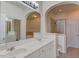 Well-lit bathroom featuring double sinks, framed mirrors, soaking tub, and separate shower at 5113 Lady Of The Lake Dr, Raleigh, NC 27612