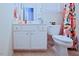 Bathroom with white vanity and colorful shower curtain at 5113 Lady Of The Lake Dr, Raleigh, NC 27612