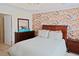 Comfortable bedroom with colorful accent wall, queen size bed, and natural light at 5113 Lady Of The Lake Dr, Raleigh, NC 27612