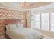 Serene bedroom with floral wallpaper, queen bed, and large windows at 5113 Lady Of The Lake Dr, Raleigh, NC 27612