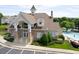 Elegant clubhouse with stone accents, manicured landscaping, and a beautiful pool in a vibrant community at 5113 Lady Of The Lake Dr, Raleigh, NC 27612
