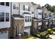 Well-maintained townhouse community with stone facades, garages, and manicured landscaping at 5113 Lady Of The Lake Dr, Raleigh, NC 27612