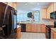 Modern kitchen features stainless steel appliances, tile backsplash, and wood cabinetry at 5113 Lady Of The Lake Dr, Raleigh, NC 27612