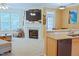 Cozy living room with fireplace, bright windows, and open floor plan to the kitchen at 5113 Lady Of The Lake Dr, Raleigh, NC 27612