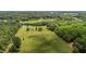 Aerial view of lush acreage featuring a pond, outbuildings and a long driveway to the house at 5200 Mrs Fuller Rd, Mebane, NC 27302