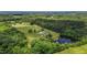 Overhead view showcasing a scenic estate with a pond, lush greenery, house and outbuildings at 5200 Mrs Fuller Rd, Mebane, NC 27302