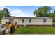 Home exterior view with a wooden deck, vinyl siding, and a well-kept lawn at 5200 Mrs Fuller Rd, Mebane, NC 27302