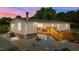Inviting backyard featuring a wooden deck and a well-maintained, gravel-covered ground at 5200 Mrs Fuller Rd, Mebane, NC 27302