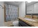 Cozy bathroom with granite countertops, shower with blue patterned curtain, and great vanity lighting at 5200 Mrs Fuller Rd, Mebane, NC 27302