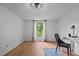 Bright bedroom features a modern ceiling fan, wood-look floors, and a view to the outside at 5200 Mrs Fuller Rd, Mebane, NC 27302