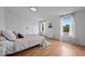 Bright bedroom features two windows, wood floors, and closet at 5200 Mrs Fuller Rd, Mebane, NC 27302
